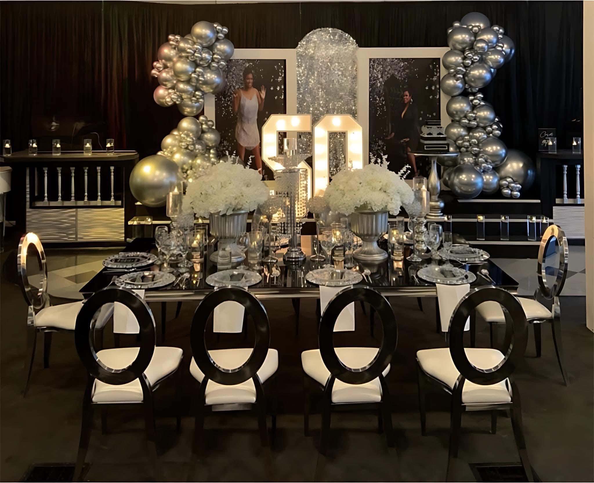 Black, silver and white 50th birthday celebration with marquee numbers and elegant tablescape