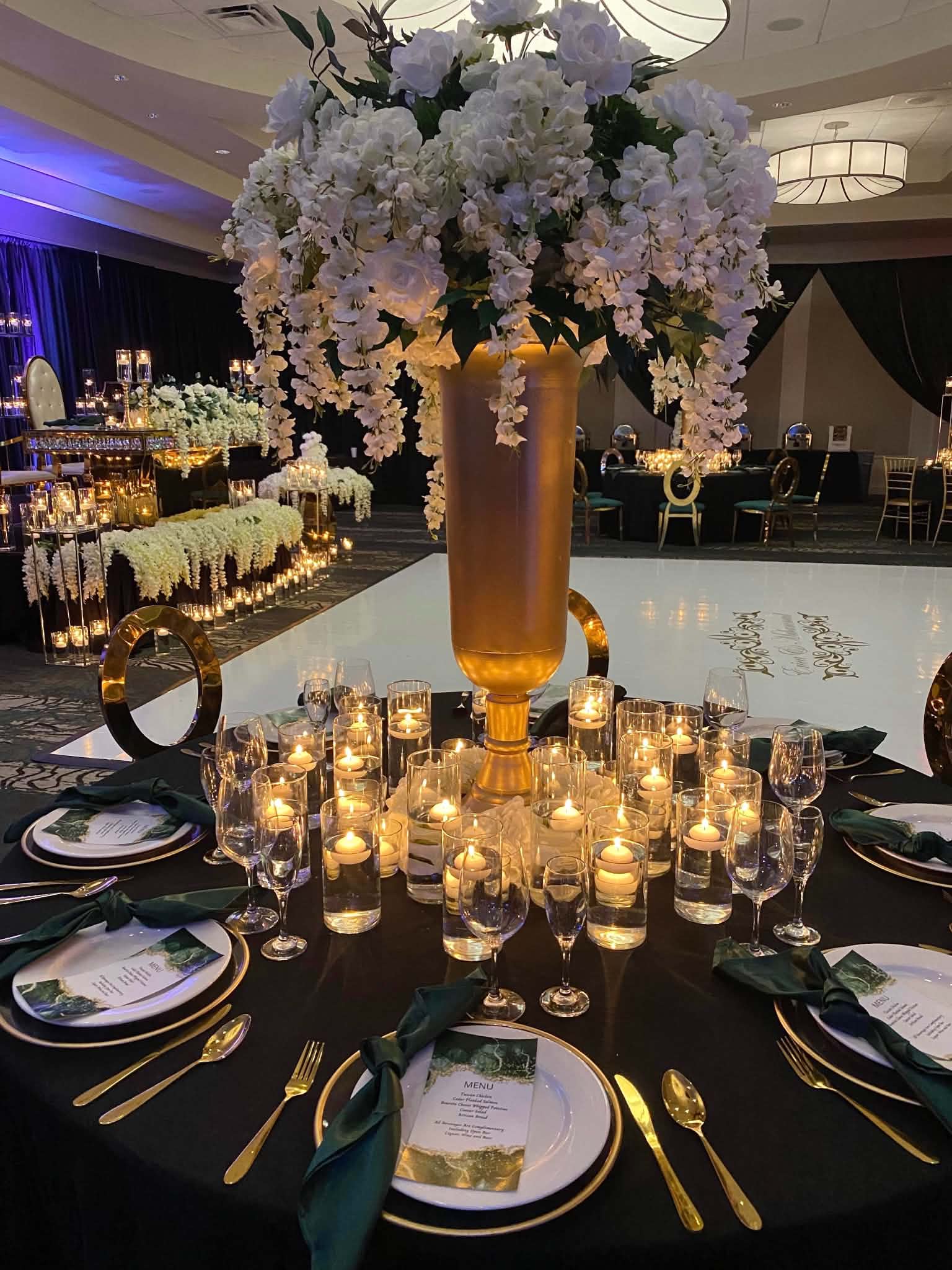 Luxury candlelit wedding reception with white florals and gold accents
