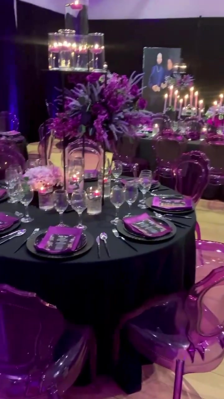 Purple candlelit event design with translucent chairs and elegant tablescapes